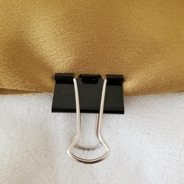 Binder clips holding fabric pieces together Binder clips holding fabric pieces together